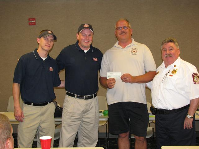 Danny Malamis, President of Jersey Mike's Team Washington, and the store's manager Shawn, presents a check to President Dmuchowski and Chief Chornock